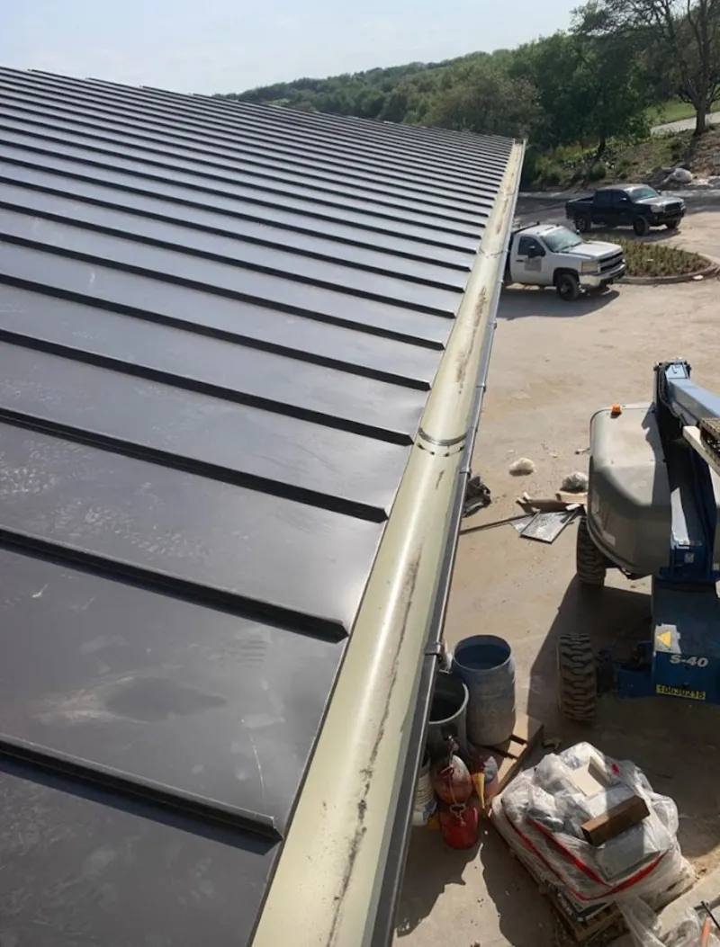 Standing seam panel and gutter detail on a metal roofing jobsite in Pleasure Point